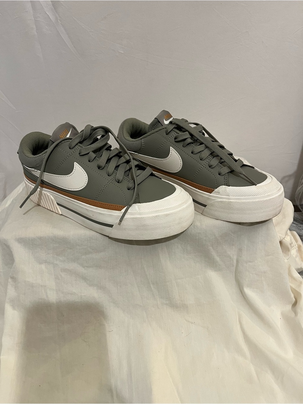 Nike  womens Olive Green Low-Top Sneakers with White Swoosh and Brown Stripe